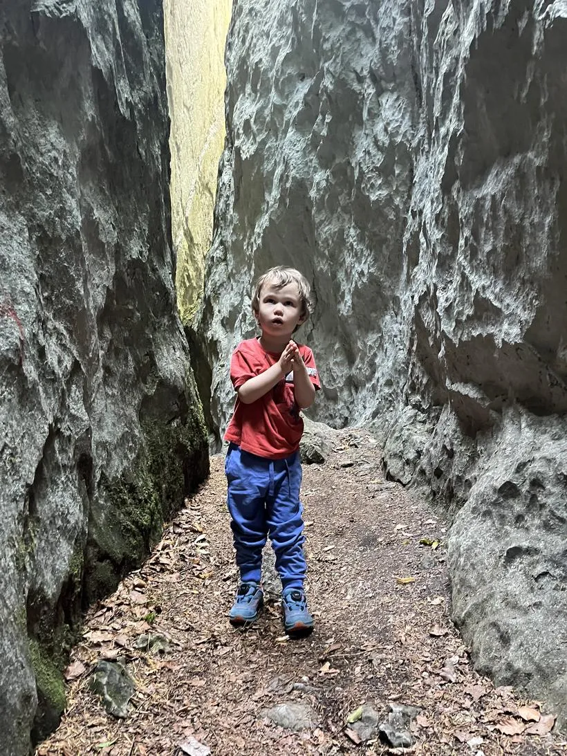 Jakob on a path between two rock faces